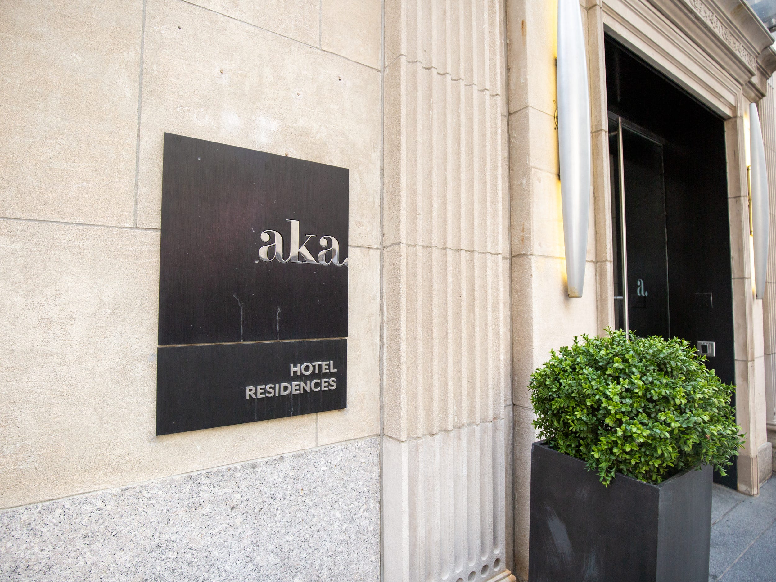 A metal plate denoting the AKA Hotel Residences building.