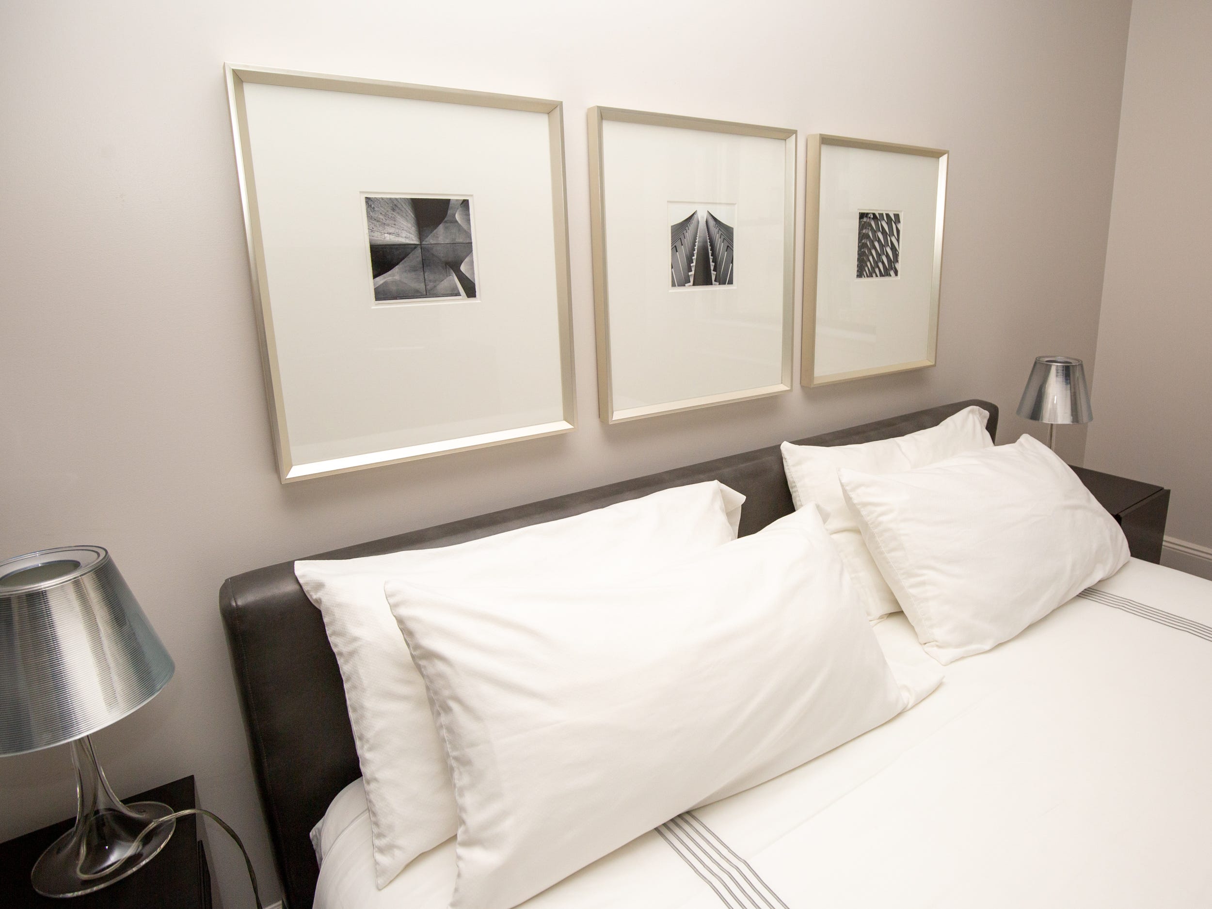 Wall art hanging above a bed with two night stands.